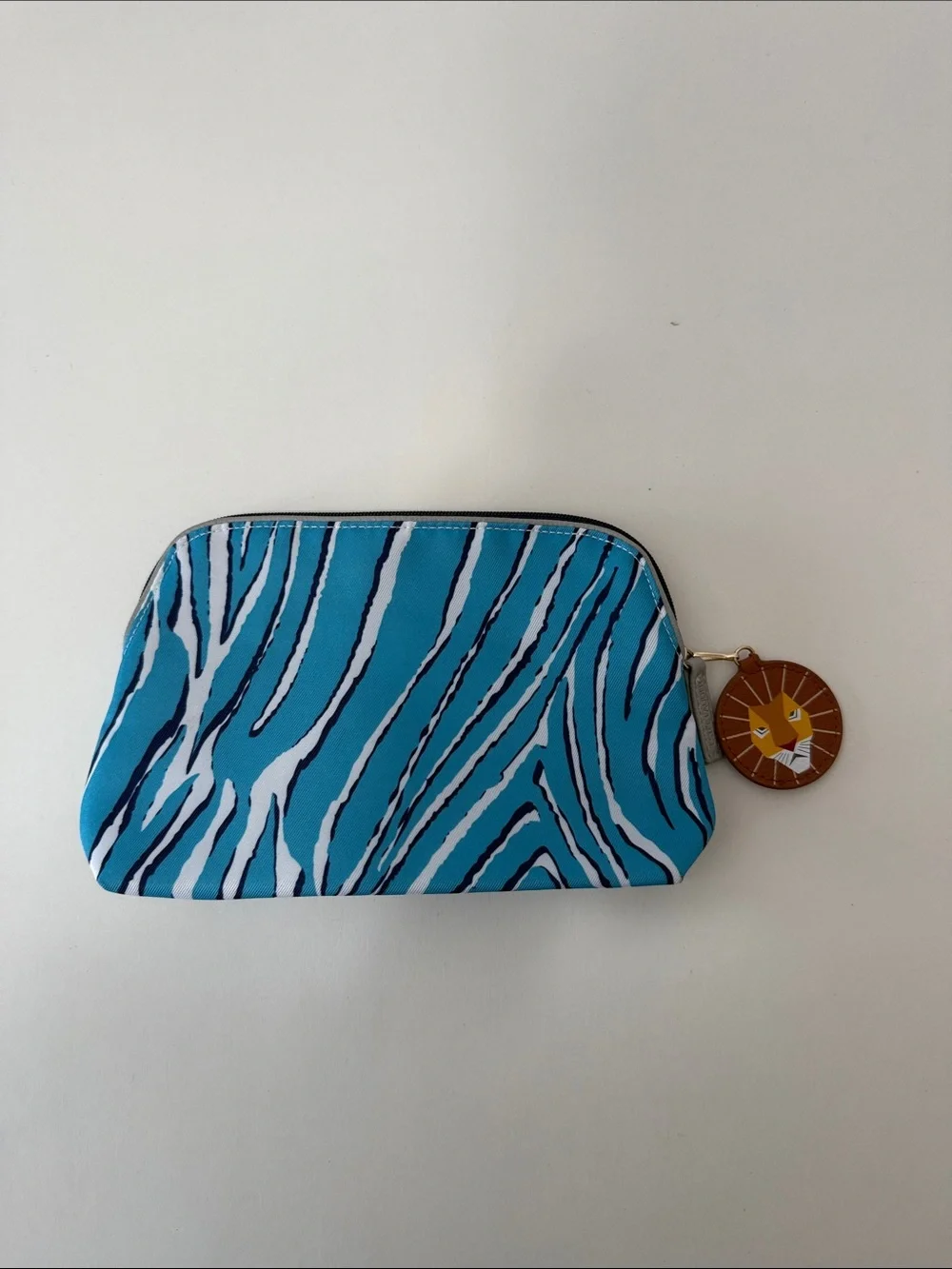 Estee Lauder Turquoise and White Zebra-Print Cosmetic Pouch with Lion Charm